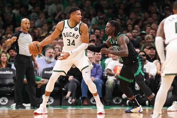 Milwaukee Bucks forward Giannis Antetokounmpo (34) defended by Boston Celtics guard Jrue Holiday (4)